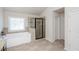 Bright primary bathroom with tile floors, soaking tub, and glass-enclosed shower at 7790 Stratford Ln, Atlanta, GA 30350