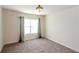 Inviting bedroom with neutral carpet, a ceiling light fixture, and a window with stylish curtains at 7790 Stratford Ln, Atlanta, GA 30350