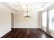 Dining room features hardwood floors, coffered ceilings, decorative wainscoting, and bright windows at 7790 Stratford Ln, Atlanta, GA 30350