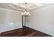 Formal dining room featuring hardwood floors, decorative molding, and elegant chandelier at 7790 Stratford Ln, Atlanta, GA 30350