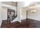 Open-concept foyer featuring hardwood floors, staircase, and view of the dining room with decorative ceilings at 7790 Stratford Ln, Atlanta, GA 30350