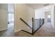 Upstairs hallway showcasing the transition from staircase to bedroom with great natural light at 7790 Stratford Ln, Atlanta, GA 30350