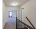 Second floor hallway with carpet and railing, leading into a bedroom with natural light at 7790 Stratford Ln, Atlanta, GA 30350