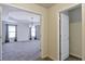 Open living space with neutral walls and carpet, featuring a view of a dining area with trey ceilings at 7790 Stratford Ln, Atlanta, GA 30350