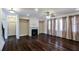 Bright living room featuring hardwood floors, fireplace, large windows, and neutral paint colors at 7790 Stratford Ln, Atlanta, GA 30350