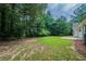 Picturesque backyard featuring lush green grass, mature trees, and a patio area for relaxation and enjoyment at 40 Heather Woods Ct, Covington, GA 30016