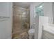 Tiled shower with glass door, built-in bench, and window in neutral Primary bathroom at 40 Heather Woods Ct, Covington, GA 30016