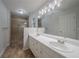 Bathroom with double sink vanity, updated lighting, and separate tiled shower at 40 Heather Woods Ct, Covington, GA 30016