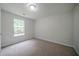 Bedroom featuring neutral walls, carpet floors, and natural light from window at 40 Heather Woods Ct, Covington, GA 30016