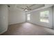 Bright bedroom featuring neutral walls, carpet floors, two windows, and a ceiling fan at 40 Heather Woods Ct, Covington, GA 30016
