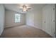 Bright bedroom featuring neutral carpet, a ceiling fan, and a window that offers natural light at 40 Heather Woods Ct, Covington, GA 30016
