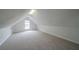 Large bonus room provides ample space, with natural light from a window and neutral walls at 40 Heather Woods Ct, Covington, GA 30016