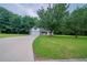 Inviting home featuring an attached garage and a long driveway on a lush green lawn at 40 Heather Woods Ct, Covington, GA 30016