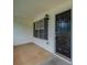 Front porch area featuring a black front door, light fixture, and white siding with dark shutters at 40 Heather Woods Ct, Covington, GA 30016