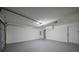 Well-lit garage featuring a large overhead door and a side entry door, with neutral paint and lighting at 40 Heather Woods Ct, Covington, GA 30016