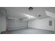 Spacious garage showing a large overhead door, and an electrical panel box for added functionality at 40 Heather Woods Ct, Covington, GA 30016