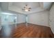 Spacious living room with hardwood floors and a ceiling fan, open to kitchen area at 40 Heather Woods Ct, Covington, GA 30016
