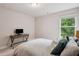 Cozy bedroom featuring a desk and bright natural light through the window at 5662 Valley Loop, Fairburn, GA 30213
