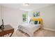 Bright bedroom with yellow headboard and natural light from the window at 5662 Valley Loop, Fairburn, GA 30213