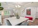 Bright dining room features modern chandelier, elegant arches, and stylish decor and a marble table top at 5662 Valley Loop, Fairburn, GA 30213
