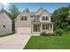 Inviting two-story home with a brick facade, charming front porch, and well-maintained landscaping at 5662 Valley Loop, Fairburn, GA 30213