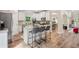 Open kitchen boasts white cabinets, granite countertops, and a center island with barstool seating at 5662 Valley Loop, Fairburn, GA 30213