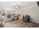 Relaxing living area offers hardwood flooring, comfortable seating, and seamless flow into eat-in kitchen at 5662 Valley Loop, Fairburn, GA 30213