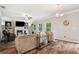 Cozy living room with a fireplace, large windows, and stylish furniture is great for entertaining at 5662 Valley Loop, Fairburn, GA 30213