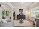 Cozy living room boasts natural light, hardwood floors, modern decor, and open access to other rooms at 5662 Valley Loop, Fairburn, GA 30213