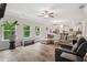Open-concept living space with a fireplace, large windows, and a view into the adjacent eat-in kitchen at 5662 Valley Loop, Fairburn, GA 30213