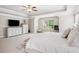 Bright main bedroom with a large window, ceiling fan and neutral carpeting, creating a peaceful environment at 5662 Valley Loop, Fairburn, GA 30213