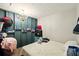 A simple bedroom with a chandelier, painted wall, and storage shelves at 6126 Knights Ln, Douglasville, GA 30135