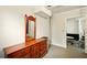 Bedroom featuring a wood dresser with a mirror, and access to the living room at 6126 Knights Ln, Douglasville, GA 30135