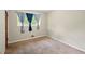 Neutral bedroom featuring carpet, a window with stylish curtains, and ample space for personalization and comfort at 6126 Knights Ln, Douglasville, GA 30135