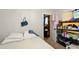 Modest bedroom with a door leading out and shelving at 6126 Knights Ln, Douglasville, GA 30135