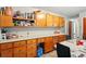 Kitchen with ample wood cabinets, a long countertop, and a dining area, offering generous space for meal preparation and dining at 6126 Knights Ln, Douglasville, GA 30135