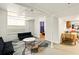 Cozy living room features a black futon, area rug, and access to the kitchen at 6126 Knights Ln, Douglasville, GA 30135