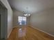 Elegant dining room features hardwood floors, a modern chandelier, and a large window at 983 Noble Oak Ct, Lawrenceville, GA 30046