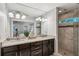 Bathroom featuring double vanity sinks with granite countertops and a tiled walk-in shower at 1735 Jobeth Se Ave, Atlanta, GA 30316