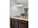 Modern bathroom vanity with granite countertops, dark cabinetry, and decorative lighting fixture at 1735 Jobeth Se Ave, Atlanta, GA 30316