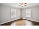 Bright, empty bedroom with hardwood floors and natural light streaming through large windows at 1735 Jobeth Se Ave, Atlanta, GA 30316