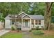 Charming bungalow with a welcoming front porch and mature trees enhancing curb appeal at 1735 Jobeth Se Ave, Atlanta, GA 30316