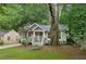 Quaint home featuring a well-manicured lawn and a spacious yard with mature trees at 1735 Jobeth Se Ave, Atlanta, GA 30316