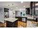 Modern kitchen with dark cabinets, granite countertops, and stainless steel appliances at 1735 Jobeth Se Ave, Atlanta, GA 30316