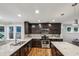 Well-lit kitchen with stainless steel appliances, dark cabinets, and granite countertops at 1735 Jobeth Se Ave, Atlanta, GA 30316
