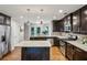 Spacious kitchen with stainless steel appliances, dark wood cabinets, and a granite island at 1735 Jobeth Se Ave, Atlanta, GA 30316