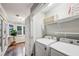 Conveniently located laundry room equipped with a washer, dryer, and storage shelving, adjacent to a sunroom at 1735 Jobeth Se Ave, Atlanta, GA 30316