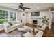 Bright living room with hardwood floors, fireplace, and large windows for natural light at 1735 Jobeth Se Ave, Atlanta, GA 30316