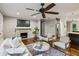 Open living room with a fireplace, hardwood floors, and connection to the kitchen at 1735 Jobeth Se Ave, Atlanta, GA 30316