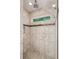Modern bathroom shower with neutral tiling, glass door and a convenient built-in storage niche at 1735 Jobeth Se Ave, Atlanta, GA 30316